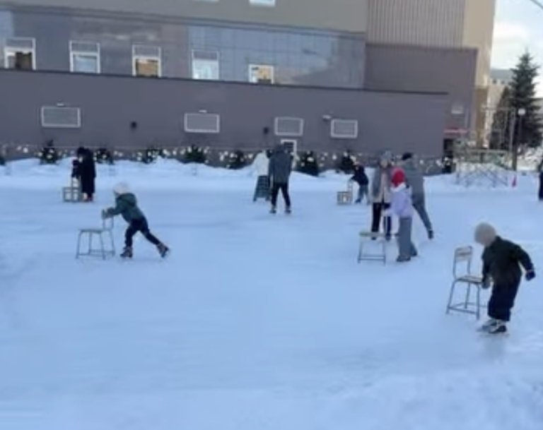 Skaters and chairs on the natural-ice rink at Tokachi Ice Park Plus during the day